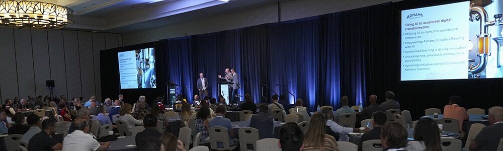 Wide shot of the INFOCUS 2025 keynote featuring Paul Houtkooper and Jon Green